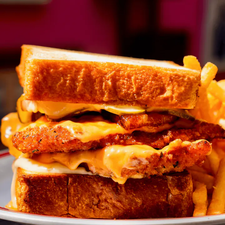 Hot Honey Chicken Melt, breaded chicken cutlets and melted cheese on thick toasted bread, with fries on the side at Uncle Rocco