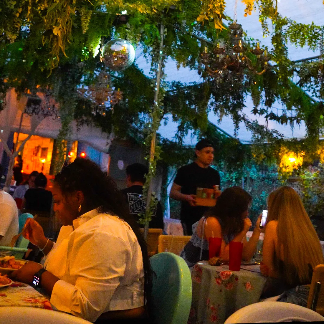 Guests seated for dinner in the Uncle Rocco backyard